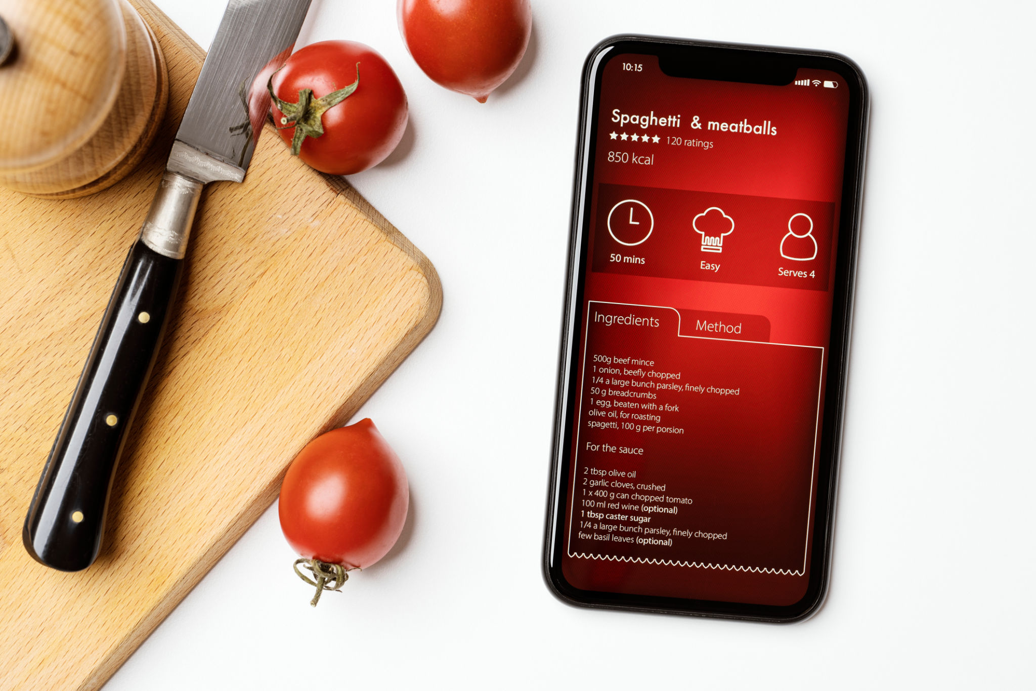 Recipe app on phone with tomatoes nearby.
